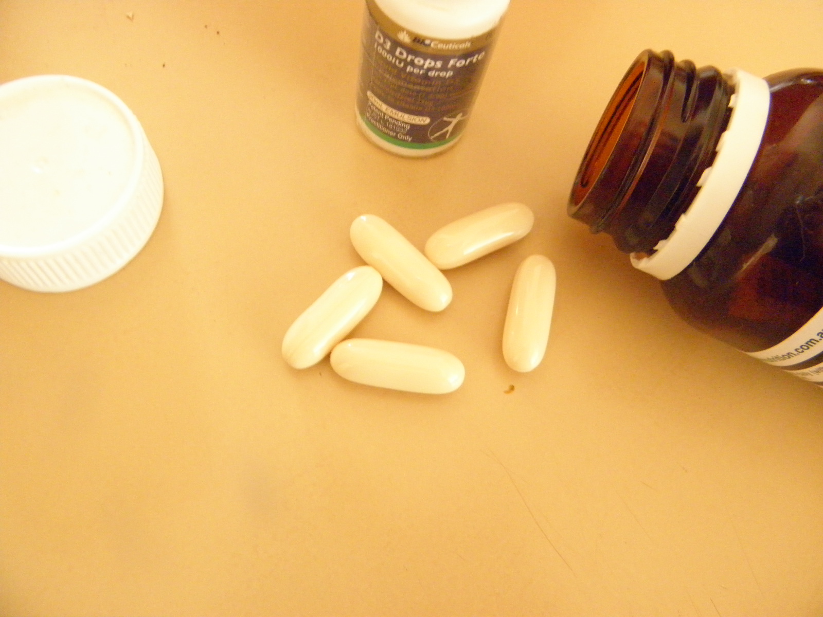 calcium supplement tablets, bottle and vitamin D supplement bottle