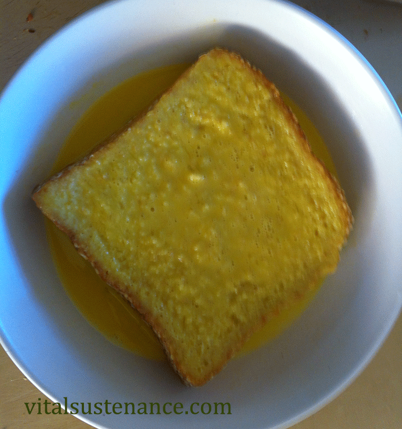 slice of whole wheat bread in bowl of egg and milk