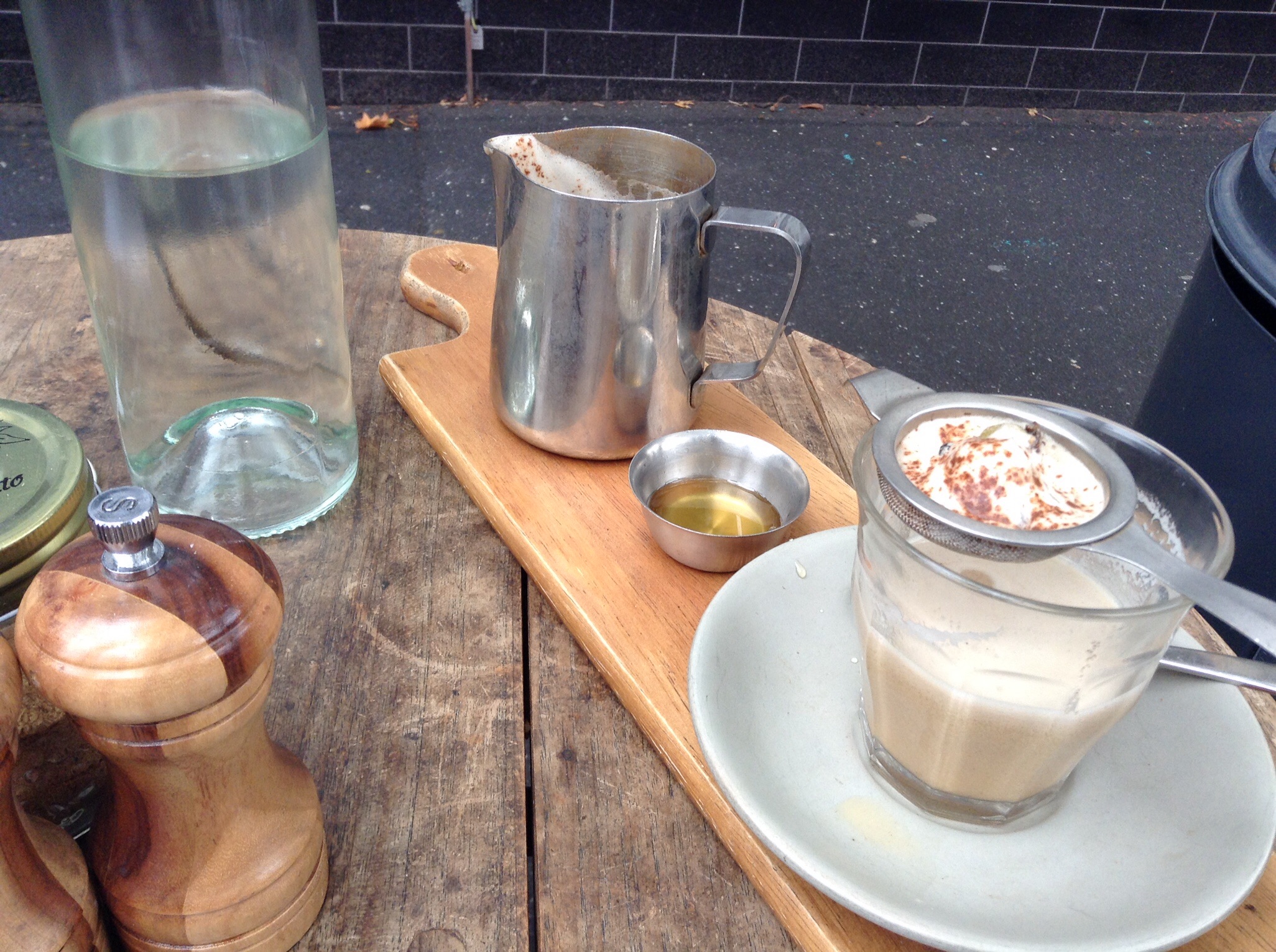 Frothy almond milk with honey and glass