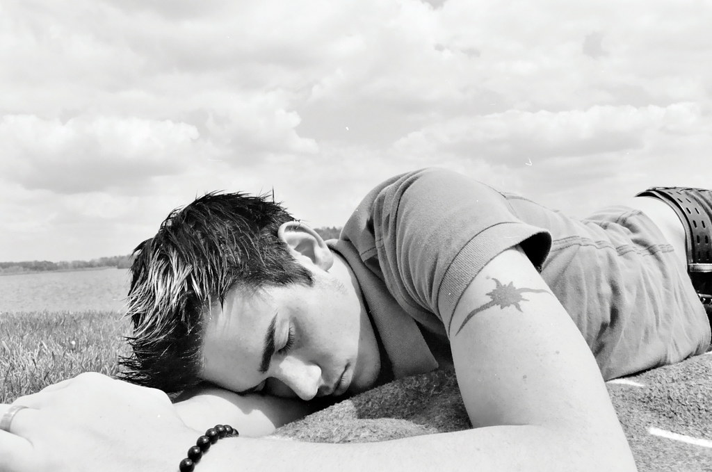 boy asleep in a field