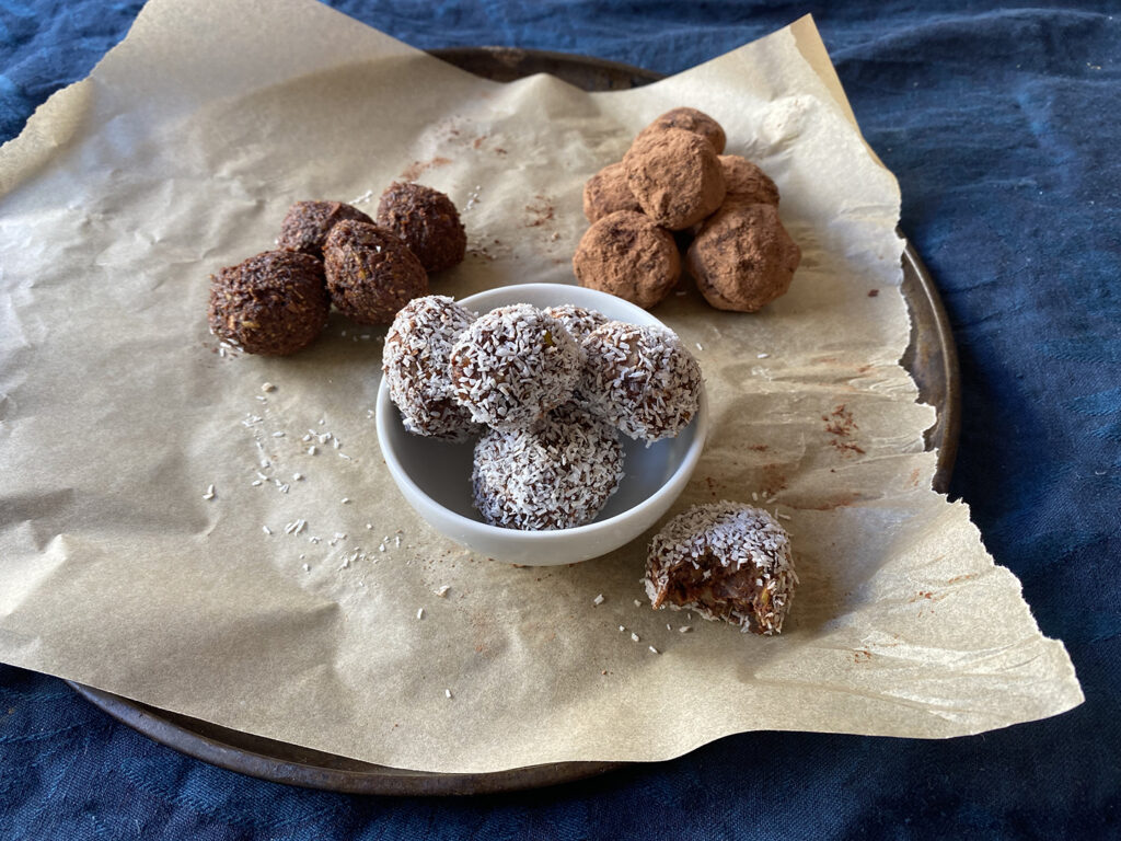cacao bliss balls - yummy! cacao balls recipe completed with bowl of balls with coconut, rolled in cacao and plain