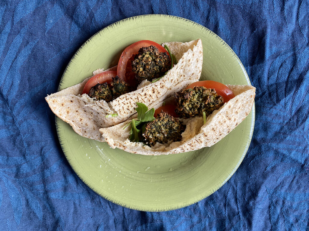 healthy baked falafel recipe - vegan baked falafel in pita bread with salad on plate