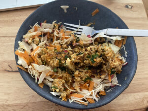 carrot and cabbage slaw with tofu and rice mess on top