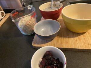 putting the protein chia seed pudding together - bowls lined up on bamboo chopping board