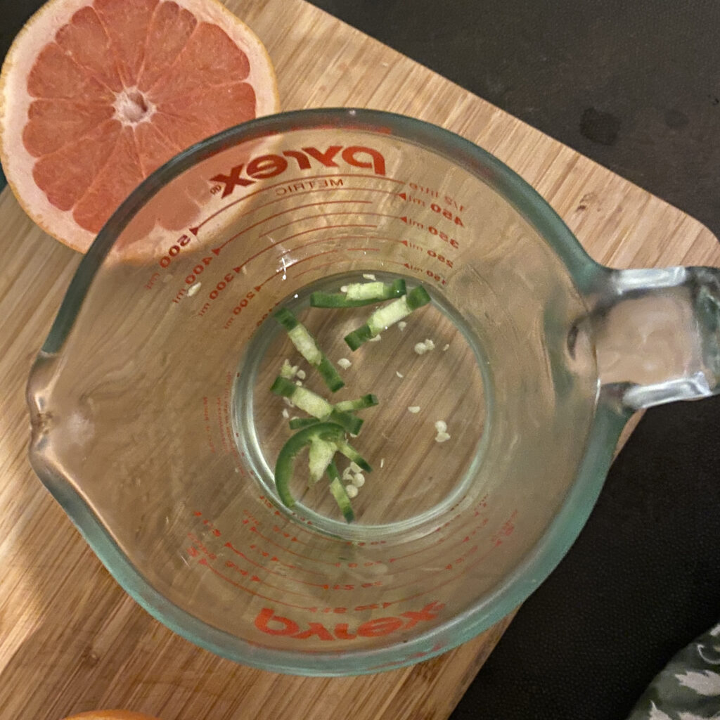 steeping jalapeno in tequila with grapefruit behind