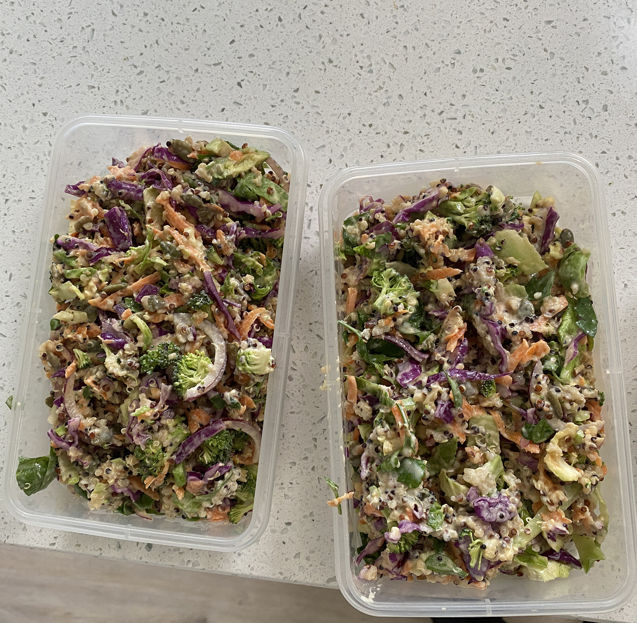 sunshine slaw with quinoa in take away containers for prep