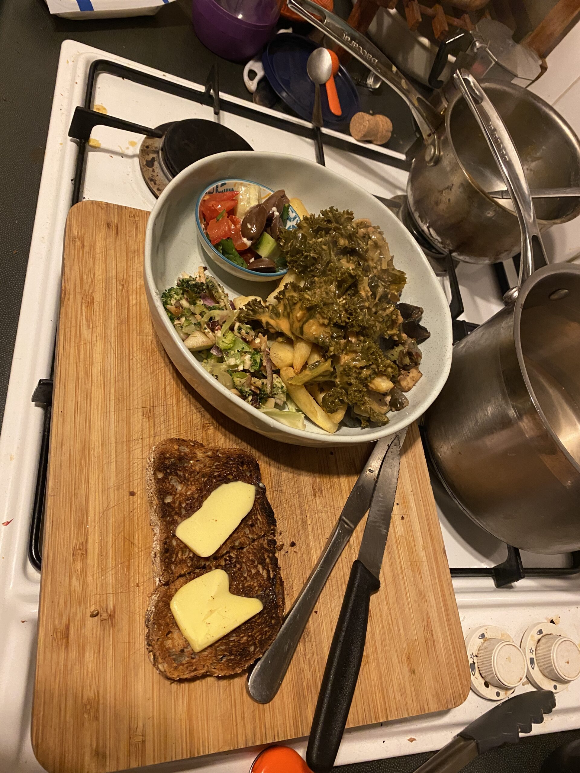 experimental dinner of a variety of salads and a piece of toast with butter - sarah's kitchen
