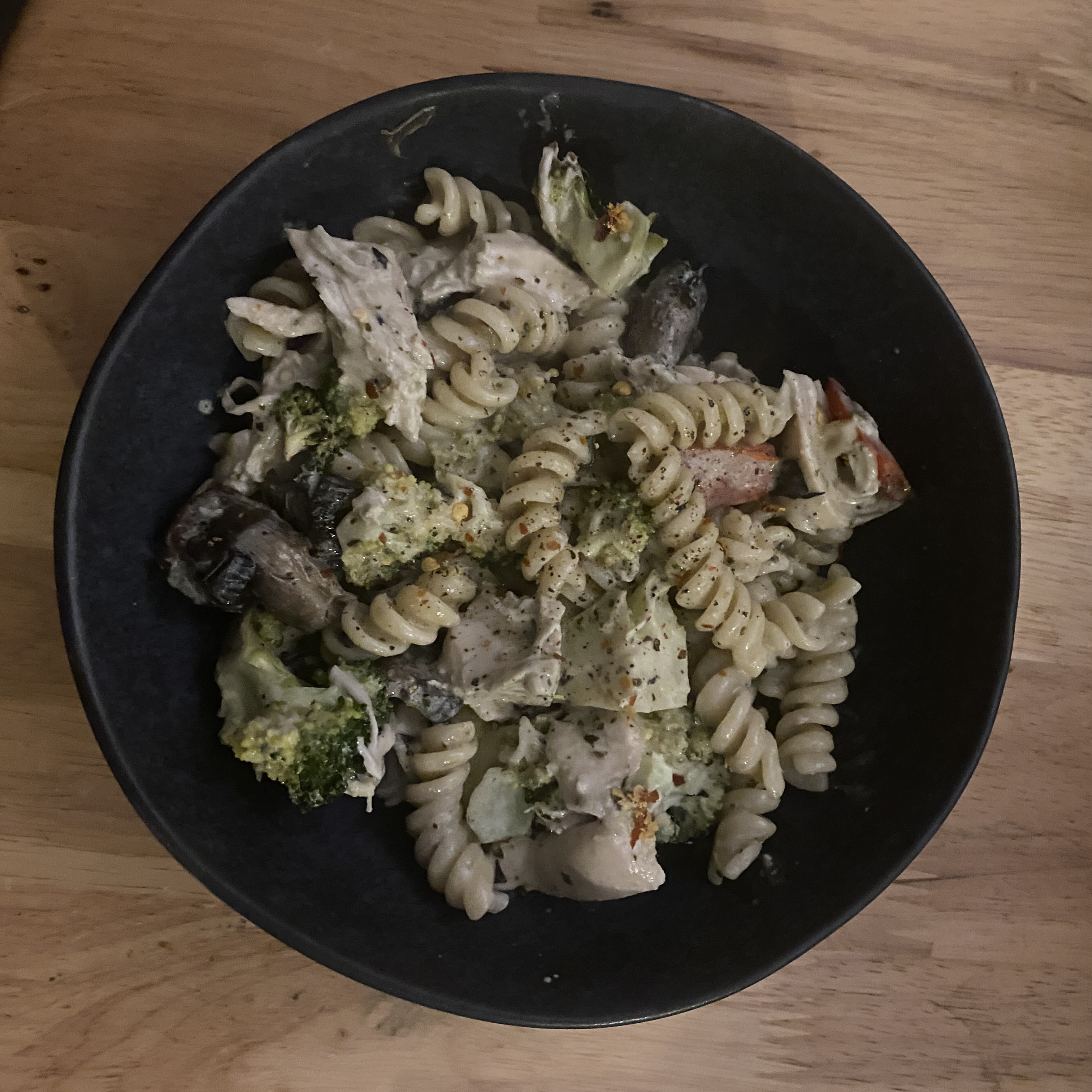 creamy mushroom pesto chicken pasta in a bowl