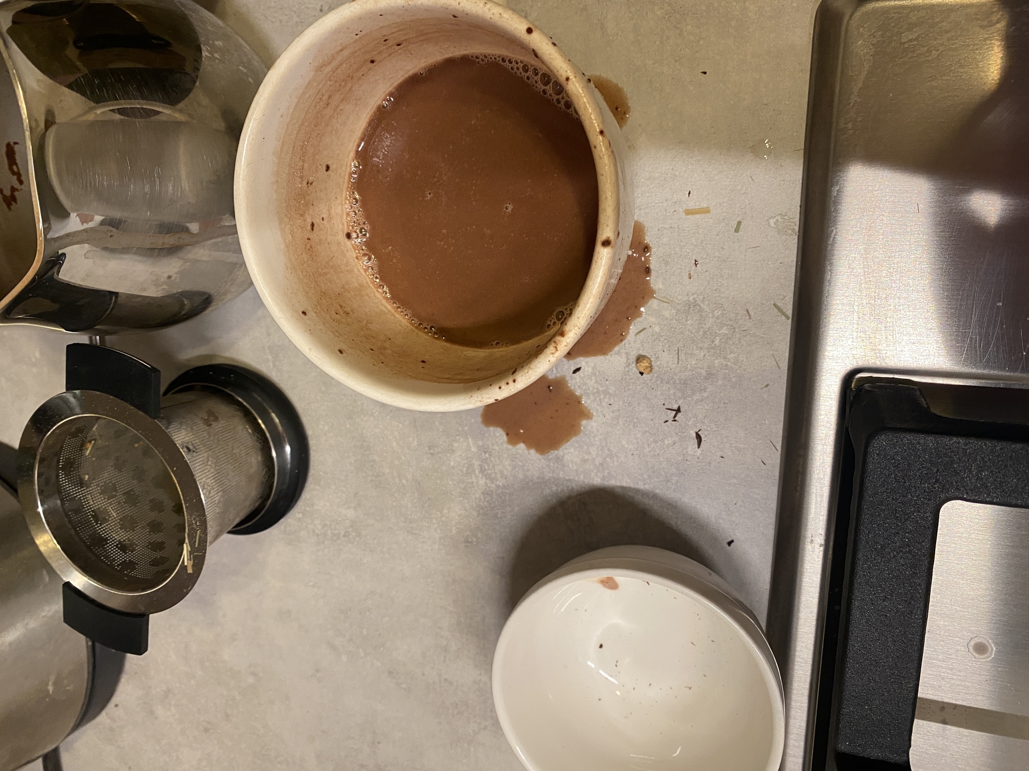 second helpings - what is LEFT of the chocolate - a half filled cup and some sprinklings of hot chocolate around