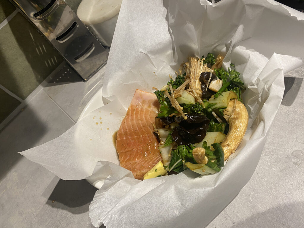 roasting dish with salmon fillet, broccolini, gourmet mushrooms in