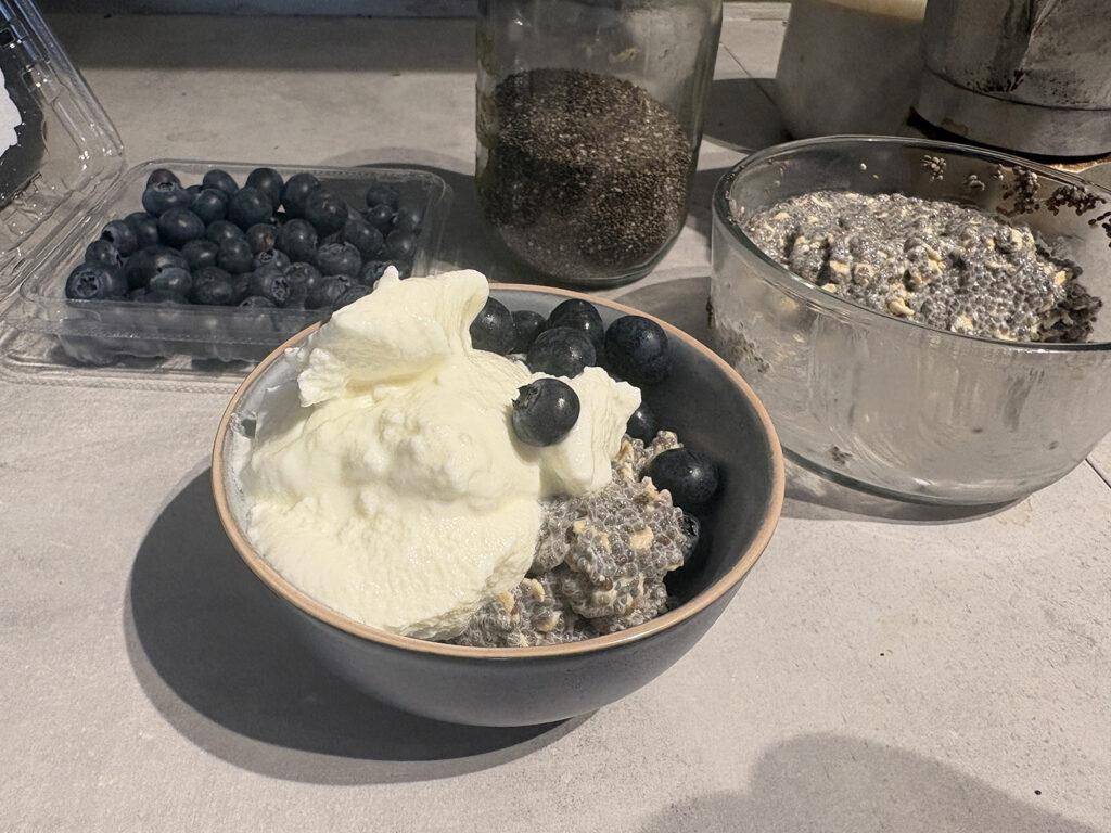 chia pudding breakfast with greek yoghurt and blueberries and jar of chia seeds, blueberries and coffee moka pot