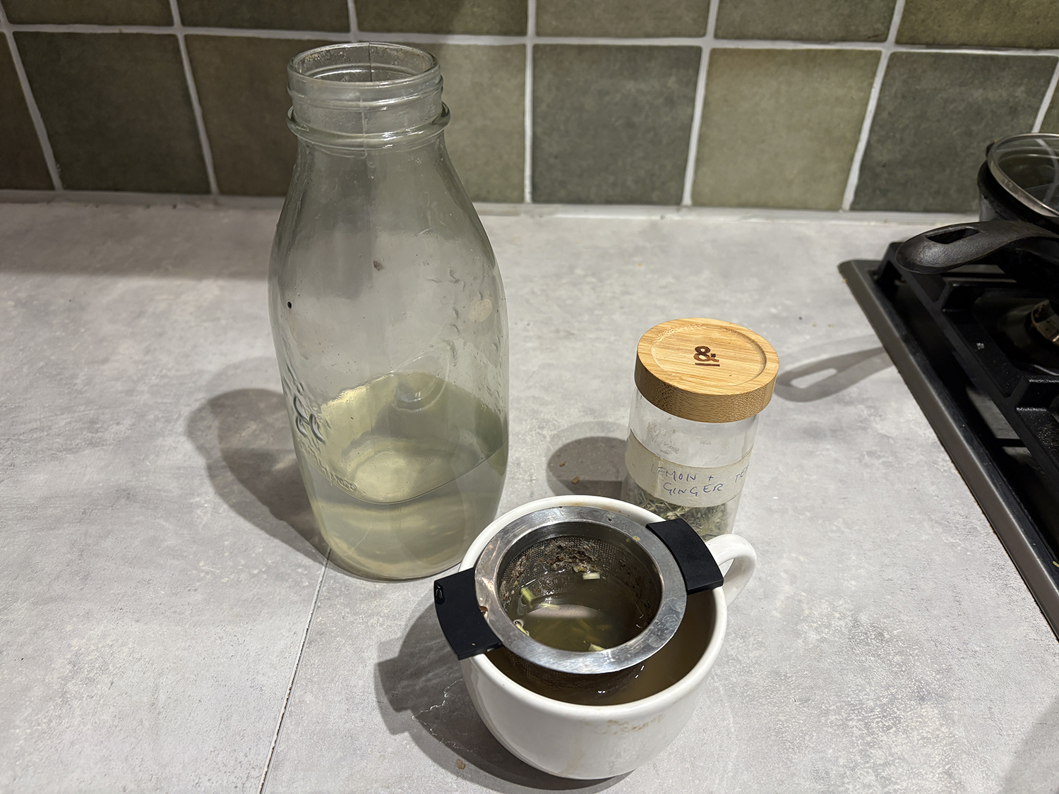 benefits of intermittent fasting - hydration - tea cup with jar of herbal tea and bottle of water