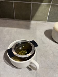 cup with herbal tea steeping