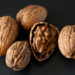 cracked walnuts, showing the nut in a shell - many people ask why do walnuts look like brains. An understanding of walnuts and brain health and the history of walnuts helps to answer this question